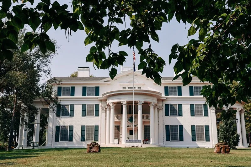 Arbor Lodge Mansion framed by leaves.