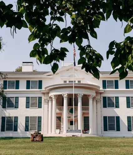 Arbor Lodge Mansion framed by leaves.
