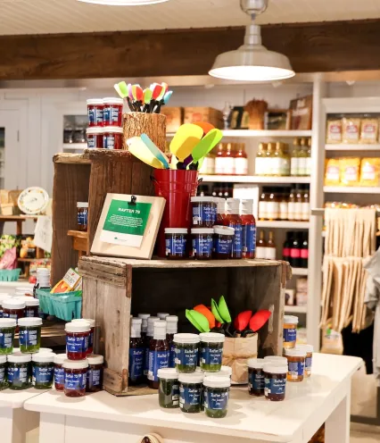 A retail store interior showcasing a variety of items on display, including clothing, accessories, and home goods.