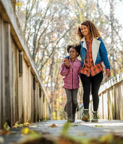 Mom and Daughter walking along the bridge on Doug's Trail