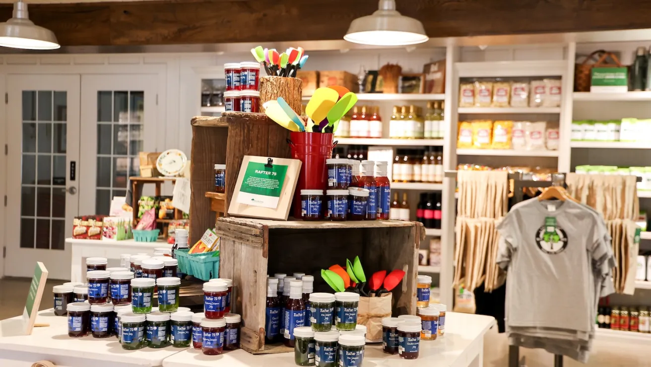 A retail store interior showcasing a variety of items on display, including clothing, accessories, and home goods.